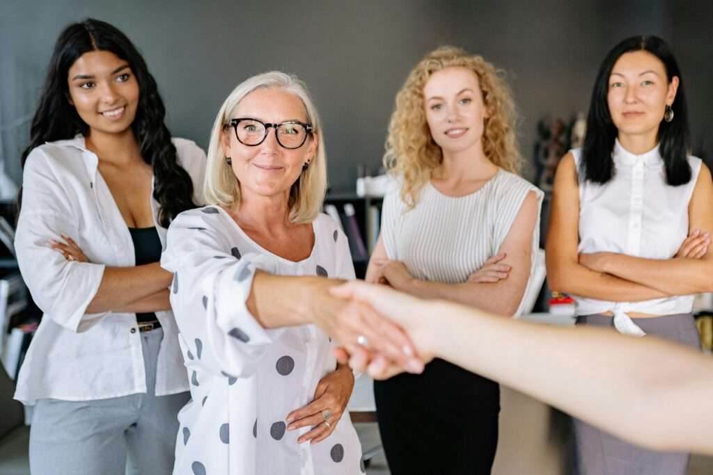 a group of women shaking hands